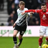 TOUGH TRIP: Barnsley's Nicky Cadden (right) is challenged by Derby County's Jake Rooney at Pride Park on Sunday afternoon. Picture: Gareth Copley/Getty Images.