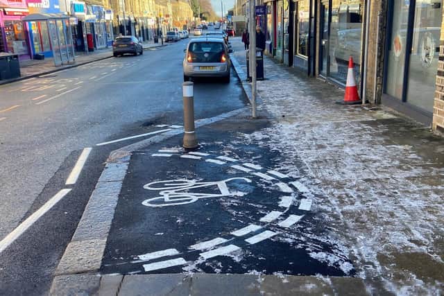 Council chiefs have been blasted for wasting tax payer’s money after their workers painted a “weird” semi-circular cycle lane on a town’s main road