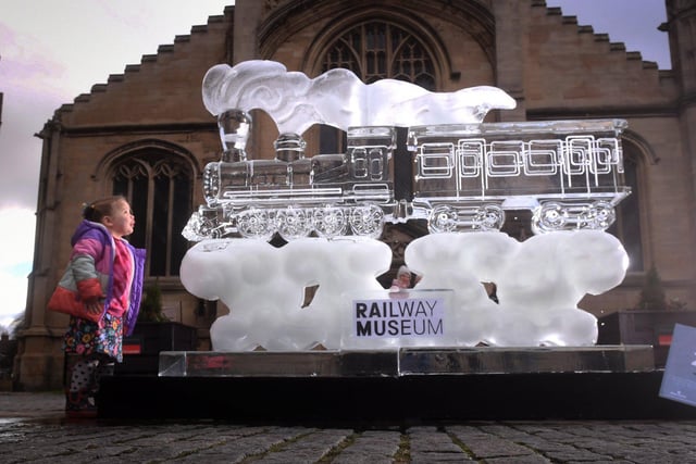 Quinn Hilton aged 3 from Wetherby looks at an Ice Sculpture which shows the National Railway Museum.