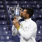 Novak Djokovic of Serbia poses for the media as he kisses his winners trophy after defeating Daniil Medvedev of Russia during their Men's Singles Final at Flushing Mewadows in New York (Picture: Clive Brunskill/Getty Images)