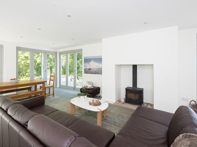 This spacious room is perfect for enjoying a nice cup of tea and has a large bay window and period fireplace flanked by Arts and Crafts style bench seating.