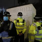Female police officers surround the statue of Winston Churchill on  Parliament Square Garden during a protest criticising the actions of the police at Sarah Everard's vigil on Parliament Square Garden on March 14, 2021 in London. (Photo by Hollie Adams/Getty Images)