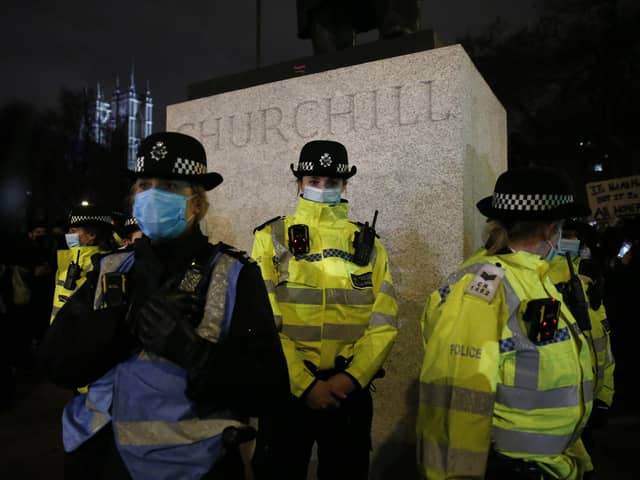 Female police officers surround the statue of Winston Churchill on  Parliament Square Garden during a protest criticising the actions of the police at Sarah Everard's vigil on Parliament Square Garden on March 14, 2021 in London. (Photo by Hollie Adams/Getty Images)
