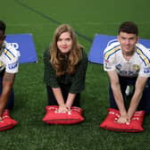 EVERY MINUTE MATTERS: Leeds United's Junior Firpo (left) and Sam Byram (right) with Isabelle Kidder, from the British Heart Foundation. Picture: JMP/Sky Bet
