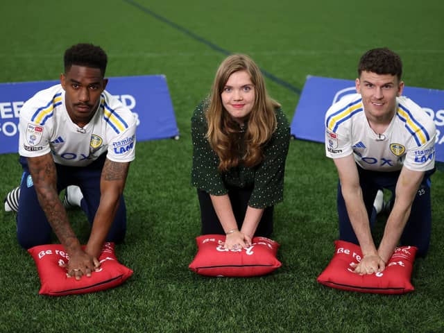 EVERY MINUTE MATTERS: Leeds United's Junior Firpo (left) and Sam Byram (right) with Isabelle Kidder, from the British Heart Foundation. Picture: JMP/Sky Bet