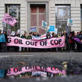 People taking part in a Cop28 London march protest outside BP headquarters at St James's Square in London. PIC: James Manning/PA Wire