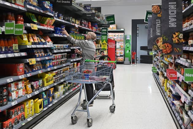 A customer looks at some goods at the Asda supermarket, in Aylesbury, England, on August 15, 2023. (Photo by JUSTIN TALLIS/AFP via Getty Images)
