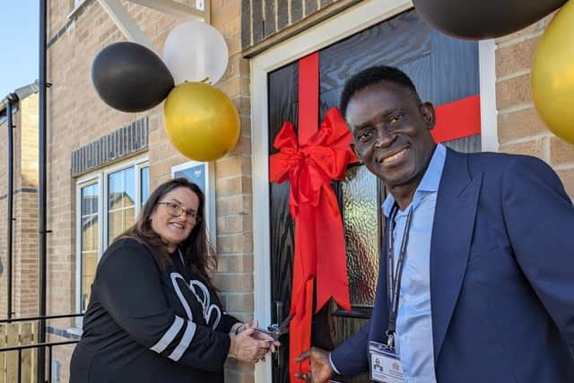 MHA Chair Rupert Pometsey and former Board member Cath Bacon cuts the ribbon to officially open one of the new homes