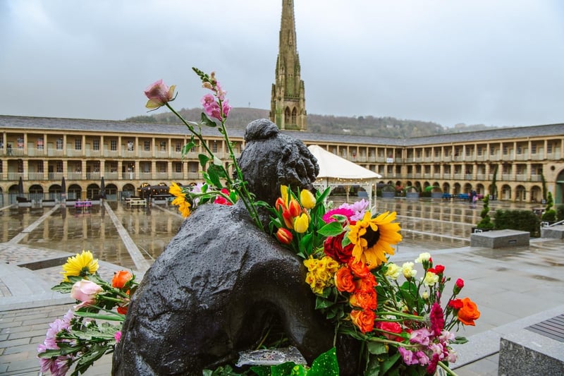 The Contemplation sculpture of Anne Lister at the Piece Hall is adorned with flowers. Credit: Ellis Robinson