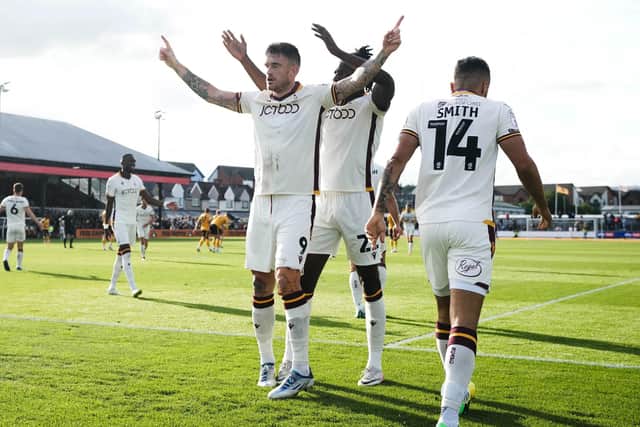 HAT-TRICK HERO: Bradford City's Andy Cook (front) celebrates after scoring his hat-trick against Newport at Rodney Parade, Newport. Picture: Robbie Stephenson/PA