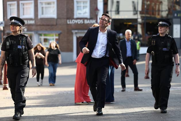 Prime Minister Andy Burnham with police officers on a walk through a town centre in Derbyshire, as part of his tour of the UK. PIC: Toby Shepheard/PA Wire