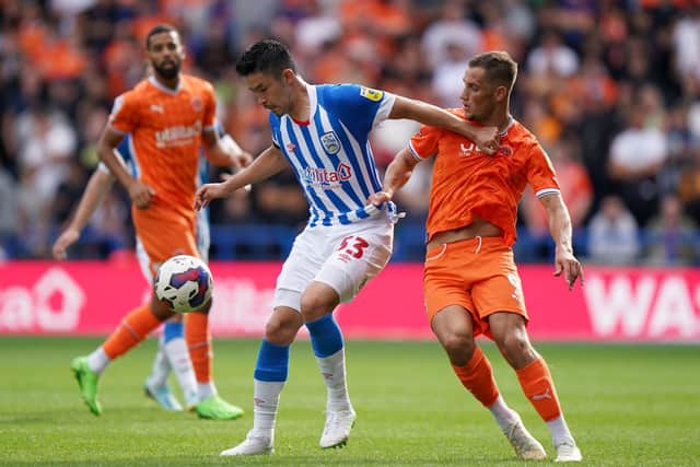 Huddersfield Town's Yuta Nakayama (left) and Blackpool's Jerry Yates battle for the ball (Picture: Tim Goode/PA Wire)