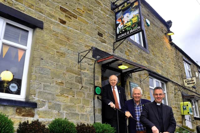 Martin Booth, centre, secretary of the Hudswell Pub Company, outside The George and Dragon