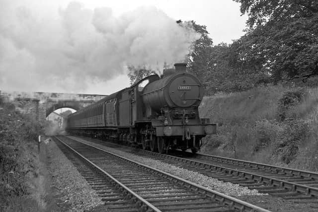A steam train passes under the bridge on its way to Tadcaster in 1957, a decade or so before the Harrogate to Church Fenton line closed