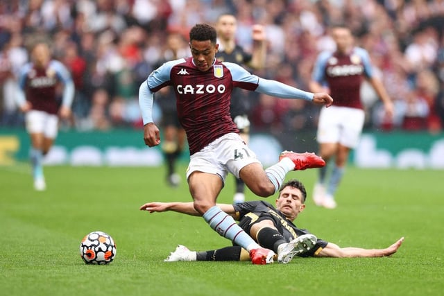 Jacob Ramsey of Aston Villa is tackled by Fabian Schar of Newcastle United during the Premier League match between Aston Villa and Newcastle United at Villa Park on August 21, 2021 in Birmingham, England.