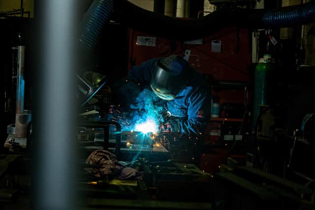 Apprentice Korey Wigglesworth welding a piece of metalwork for a lock gate in the workshop.
By Charlotte Graham