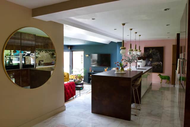The kitchen is raised to distinguish the space from the living room in the open plan arangement