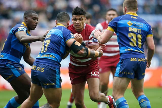 Wigan Warriors' Kai Pearce-Paul is stopped by a number of Wakefield players (Picture: Ed Sykes/SWpix.com)