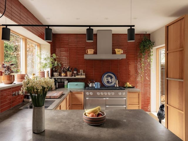 A large picture window in the kitchen frames views of the garden.