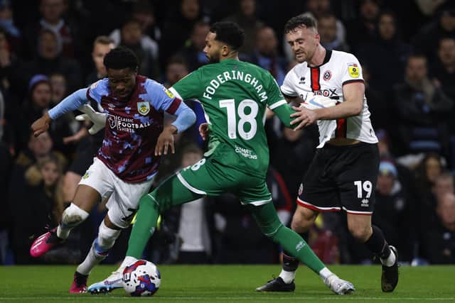 Sheffield United goalkeeper Wes Foderingham fouls Burnley's Nathan Tella (left) (Picture:: Richard Sellers/PA Wire)