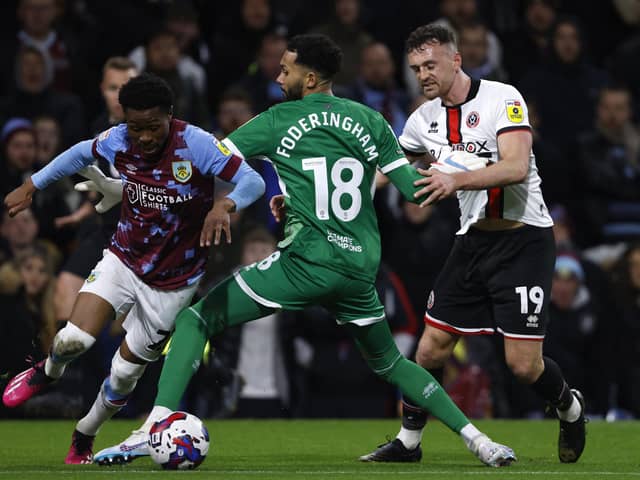 Sheffield United goalkeeper Wes Foderingham fouls Burnley's Nathan Tella (left) (Picture:: Richard Sellers/PA Wire)