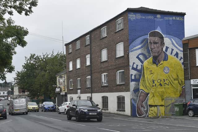 Artist Tom Crowe, from Swillington, pictured with the new Leeds United Supporters Trust Vinnie Jones mural at Whingate Junction in Armley, Leeds.