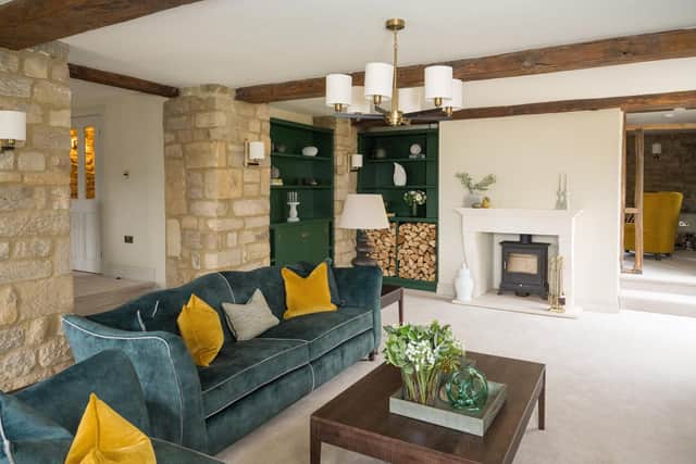 The cosy snug with in-built, bespoke cabinets in Tree Farm green by Little Greene