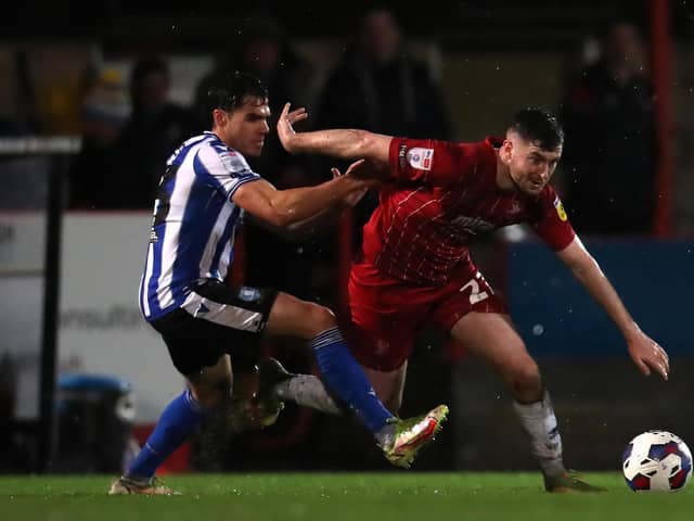 Sheffield Wednesday defender Reece James tussles with Cheltenham danger man Aidan Keena. Picture: PA.