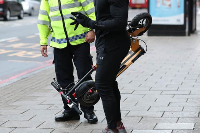 File photo dated 26/07/19 of an e-scooter rider being stopped by a police officer in Islington, London, as consumers have been warned only to buy e-bikes and e-scooters from reputable retailers following a dramatic surge in house fires caused by unsafe batteries and chargers.