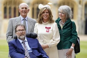 English broadcaster and journalist Kate Garraway stands with her husband Derek Draper and her parents Gordon and Marilyn Garraway, as she poses with their medal after being appointed a Member of the Order of the British Empire (MBE), following an investiture ceremony at Windsor Castle, in Windsor on June 28, 2023. (Photo by Andrew Matthews / POOL / AFP)
