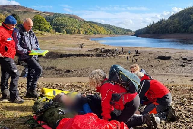Members of Edale Mountain Rescue are pictured helping a stricken walker in  the mud at the Ladybower reservoir. PIctures: Edale Mountain Rescue