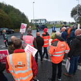 Postal workers and members of the CWU on strike outside the Royal Mail Delivery Office in Blackpool.