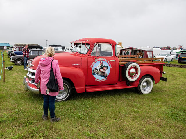 Visitors look at the vintage vehicles