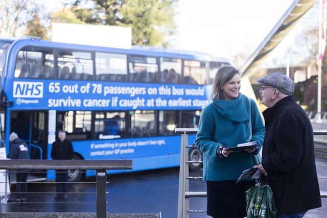 Volunteers talk to members of the public as the 'NHS Bus-ting Cancer' bus passes through. PIC: Fabio De Paola/PA Wire