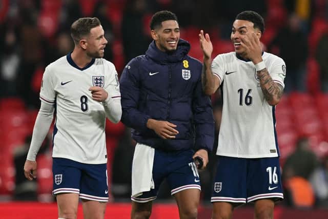 FIGHT FOR PLACES: Jude Bellingham (centre) risks being left behind if he cannot match the team ethic shown by Jordan Henderson (left) and former Middlesbrough player  Morgan Rogers (right) (Image: Glyn KIRK / AFP)