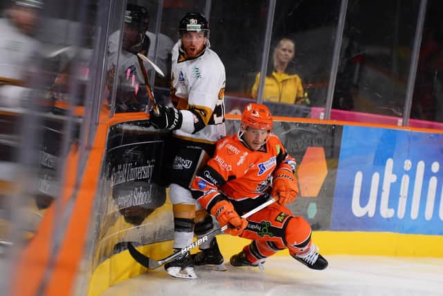 TOUGH GOING: Sheffield Steelers' captain Jonathan Phillips battles on the boards with Nottingham Panthers' Mike Hammond. Picture courtesy of Dean Woolley/EIHL.