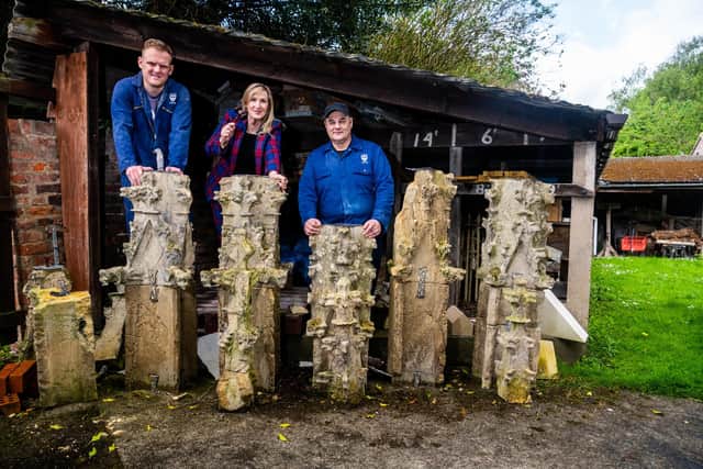 Rob Dodson, (left) and Dennis Massey, (right) both stonemasons and maintenance for Beverley Minster, with local auctioneer Caroline Hawley, behind some of the 500-year-old stone pinnacles which are up for sale. Picture By Yorkshire Post Photographer,  James Hardisty