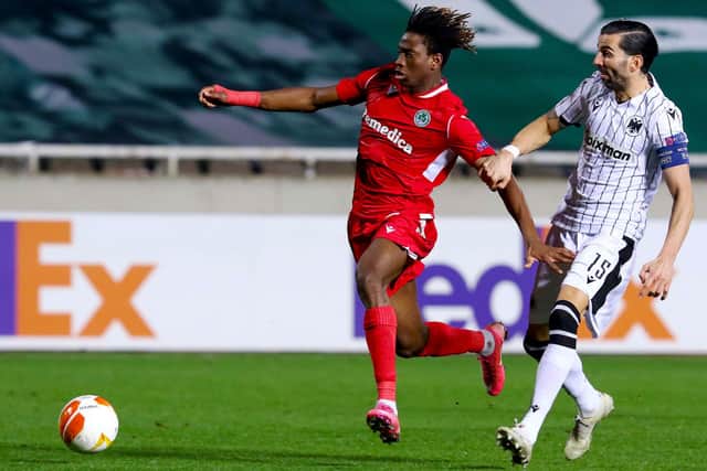 Omonoia's forward Kaly Sene (L) is marked by PAOK's defender Jose Angel Crespo during the UEFA Europa League Group E football match between Omonoia and PAOK at the GSP stadium in the Cypriot capital Nicosia, on December 3, 2020. (Photo by Sakis SAVVIDES / AFP) (Photo by SAKIS SAVVIDES/AFP via Getty Images)