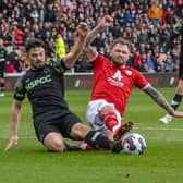 Barnsley striker James Norwood challenges Derby County rival Eiran Cashin in the club's game earlier this year at Oakwell. Picture: Tony Johnson