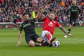 Barnsley striker James Norwood challenges Derby County rival Eiran Cashin in the club's game earlier this year at Oakwell. Picture: Tony Johnson