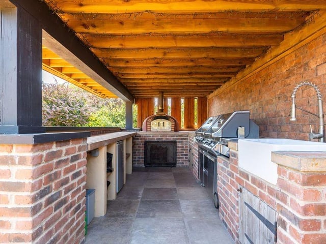 The dedicated cooking area makes it easy to prepare and serve meals outdoors, keeping guests together during summer gatherings.