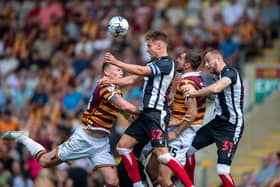 Grimsby Town's goalscorer Danny Rose beats Bradford City defender Sam Stubbs to a high ball. Picture: Bruce Rollinson