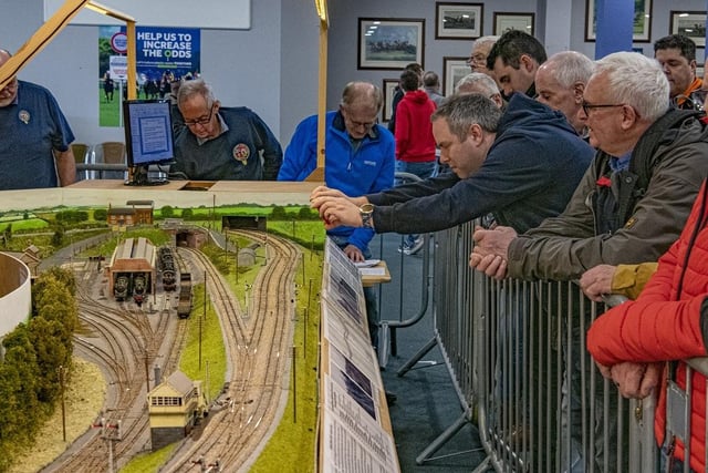 Enthusiasts take pictures of the layouts at the festival.