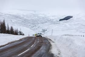 Cars make their way along the A939 after heavy snowfall in the Scottish Highlands in December 2022.