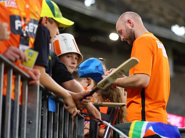 Man in demand: Adam Lyth signs autographs for young fans in Melbourne during last winter's Big Bash League. Photo by James Worsfold/Getty Images.