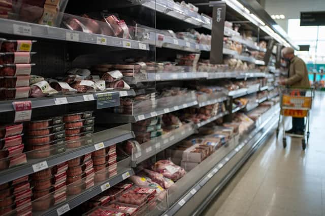 A shopper walking through the fresh meat aisle in a branch of Waitros. The price of basic groceries such as butter, milk and cheese went up 30% year-on-year at some supermarkets in December, new figures show.