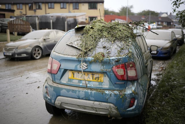 Damage is seen on a residents car as flood waters recede in the village of Catcliffe after Storm Babet flooded home, business and roads.