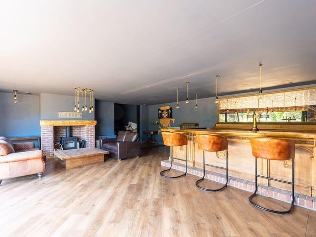 The entertainment suite also features an oak bar and a log-burning stove.