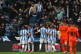 Huddersfield Town's Delano Burgzorg celebrates scoring their side's first goal of the game with team-mates during the Sky Bet Championship match at John Smith's Stadium, Huddersfield. Picture date: Saturday September 30, 2023. PA Photo. See PA story SOCCER Huddersfield. Photo credit should read: Tim Markland/PA Wire