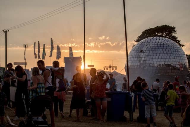 Festival goers walk at sunset as they arrive at Camp Bestival in 2018 (Photo: Matt Cardy/Getty Images)